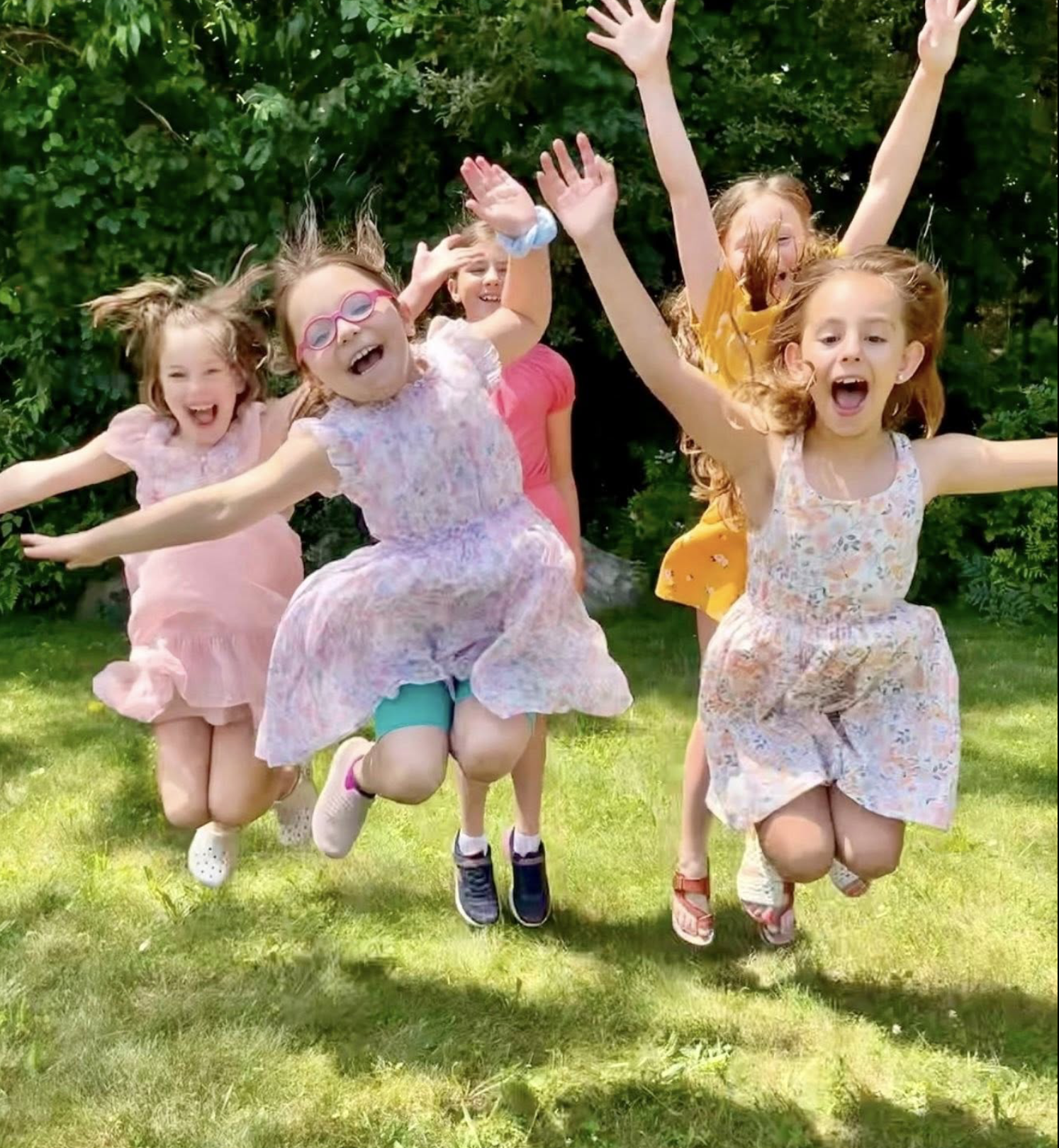 Girls at camp jumping and having fun